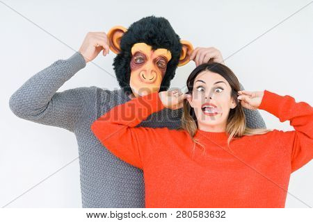 Funny young couple, boyfriend wearing monkey mask, crazy and idiot relationship in love