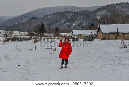 Woman Walking At Snow Village In Mohe County, Heilongjiang Province, China.