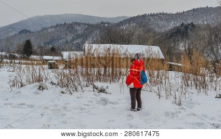 Woman Walking At Snow Village In China