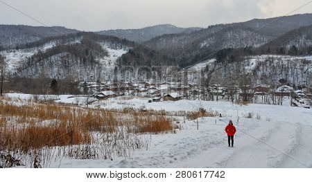 Woman Walking At Snow Village In China