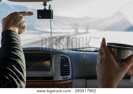 The Hand Of A Man, The Driver, Shows The Girl With A Mug Of Tea, The Direction Of The Road, In Winte