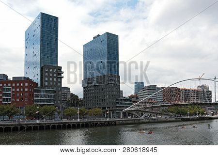 Bilbao, Spain-july 26, 2018: View On Two Towers Torres De Urbitrate And The Pedestrian Bridge Over T