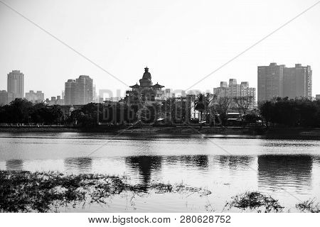 Statue Of Buddha Atop Temple Against Black And White Kaoshiung Skyline