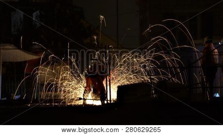 Night Scene Showing Railway Workers Cutting Iron Pieces With Disc Tool On The Track And Surrounded B