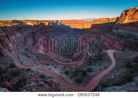 Shafer Canyon Overlook With Shafer Trail In Canyonlands National Park Located Near Moab, Utah At Sun