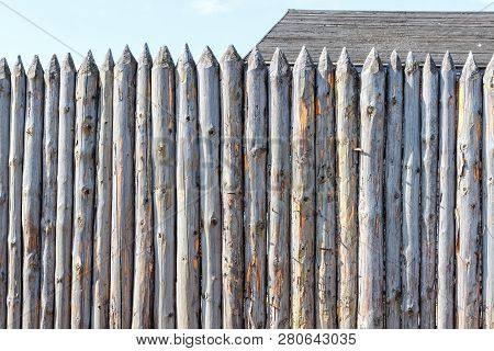 Ancient Fence From Trunks Of Trees. Protection Against Enemies In Olden Days