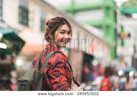 Traveler Backpacker Asian Woman Travel In Khao San Road At Bangkok, Thailand. Happy Young Female Spe