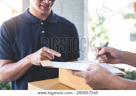 Delivery Mail Man Giving Parcel Box To Recipient And Signature Form, Young Owner Signing Receipt Of 