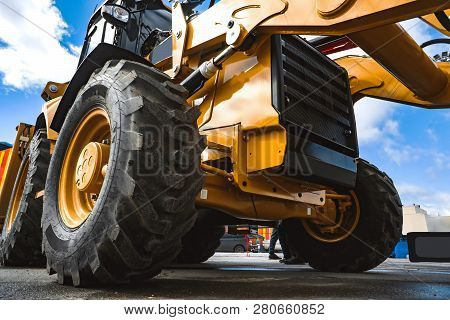 The Hydraulic Tractor Is Yellow. Crawler Bulldozer At The Exhibition
