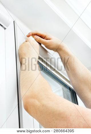 Man Installing Cassette Roller Blinds On Windows