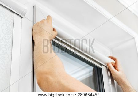 Man Installing Cassette Roller Blinds On Windows