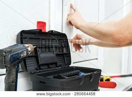 Man Installing Cassette Roller Blinds On Windows