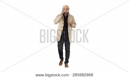 Businessman In Autumn Coat Walking And Talking On Phone On White Background.