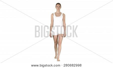 Walking Barefoot Girl In White Shorts And White Shirt On White Background.