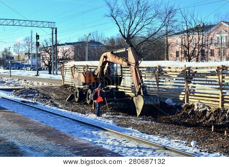 The Excavator Loads Crushed Stone In A Dump Truck Body. Construction Of The Railway. Preparing The S