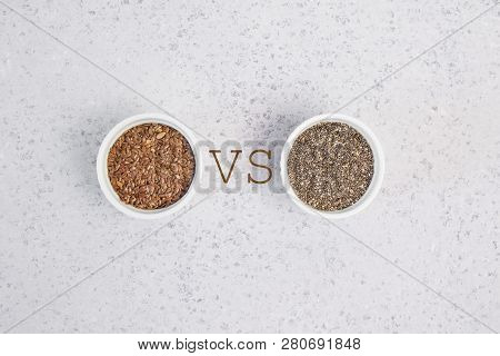 Small Bowl With Chia Seeds And Flax Seeds With Vs Sign Seen Directly From Above On Grey Background. 