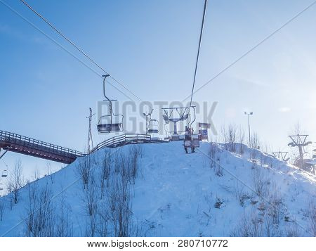 Skiers And Snouborders On A Ski Lift Pov In Winter Time. The Cable Car Lifts The Peoples Up To The S