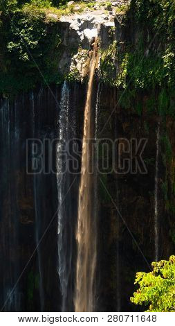Waterfall Coban Sewu In Java, Indonesia. Waterfall In Tropical Forest By Drone Tumpak Sewu