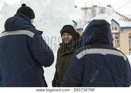 Three Workers At The Installation Of The Ice Town