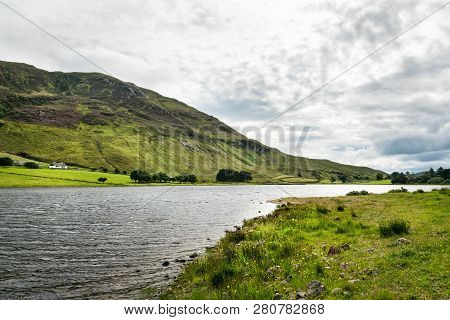 This Is A Picture Of The Lake In Fintown Donegal In Ireland.  The Lake Is At The Base Of A Mountain.