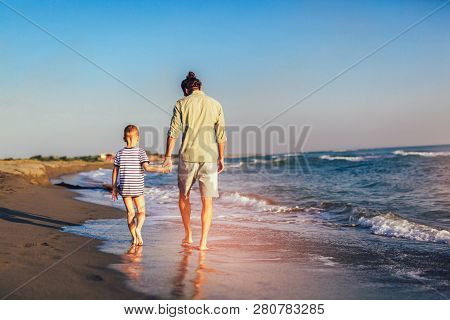 Happy Father And Son, Man & Boy Child, Running And Having Fun In The Sand And Waves Of A Sunny Beach