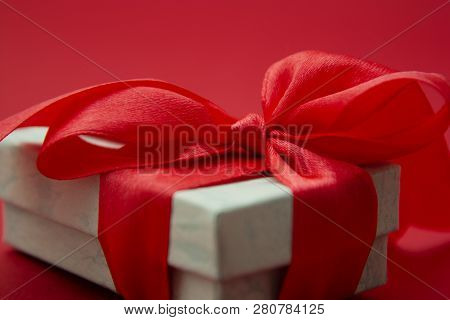 Close Up Gift Box, Birtday Gift With Red Bow On Red Background. Love, Valentine's Day, Mother's Day.