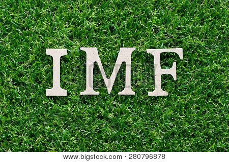 Wood Alphabet In Word Imf (abbreviation Of International Monetary Fund) On Artificial Green Grass Ba