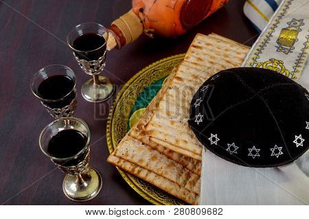Passover And Red Kosher Glasses Wine With A Matzah Haggadah On A Vintage Wood Background