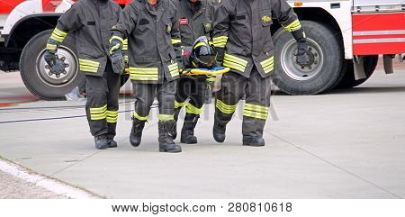 Vicenza, Vi, Italy - May 10, 2018: Italian Stretcher Bearers Firemen Transport An Injured On The Str