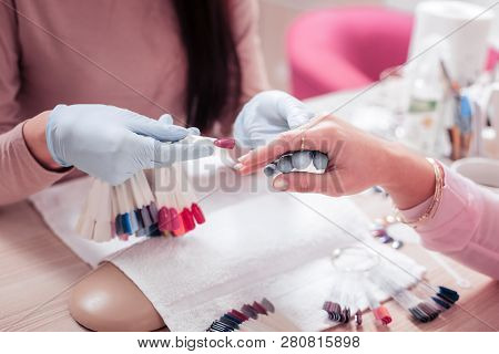 Professional Manicure Master Holding An Artificial Nail