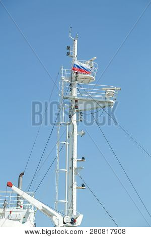 Mast Of A Large White Motor Ship In The Sea With The Flag Of Russia.