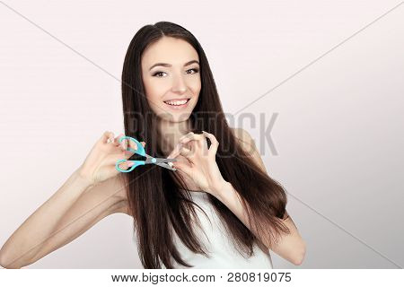 Stop Smoking Concept. Young Woman Cut Cigarettes With Scissors Happy Smiling. Focus On Hand, Scissor