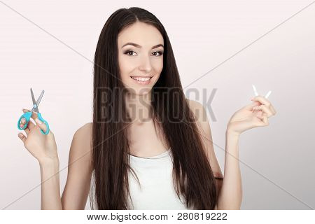 Stop Smoking Concept. Young Woman Cut Cigarettes With Scissors Happy Smiling. Focus On Hand, Scissor