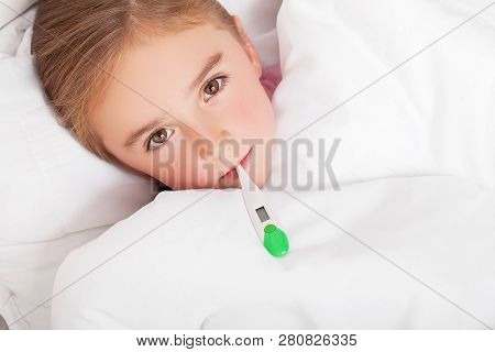 Sick Girl Resting In Bed With Fever Meassuring Temperature With