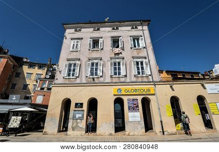Rovinj, Croatia - May 22, 2018: View On Old And Bright Buildings With Shutters In Coastal Town Of Ro