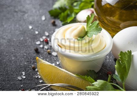 Mayonnaise Sauce And Ingredients On Black Stone Table. Close Up With Copy Space.