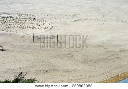 Volleyball Net On The Deserted Beach Of Praia De Odeceixe At The Estuary Of The River Seixe, Portuga