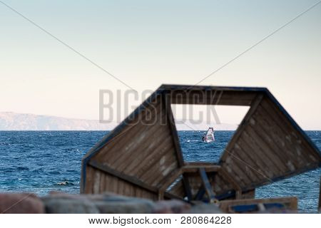 A Surfer Rides In The Gulf Of Aqaba In The Red Sea View From The Dahab Embankment Through The Missin