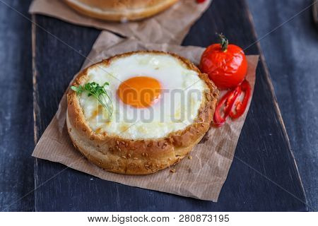 Cheese Filled Brioche With Egg Yolk And Baked Tomato