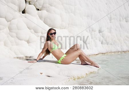 Natural Spa. Sexy Woman With Fit Suntan Body. Natural Travertine Pool Terrace In Pamukkale. Dead Sea