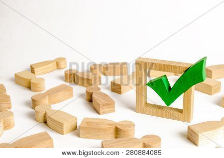 Green Tick Stands In The Middle Of The Lying Figures Of People. Voting And Election Concept. Referen