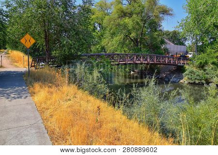 Views Of Jordan River Trail Pedestrian And Train Track Bridge With Surrounding Trees, Russian Olive,