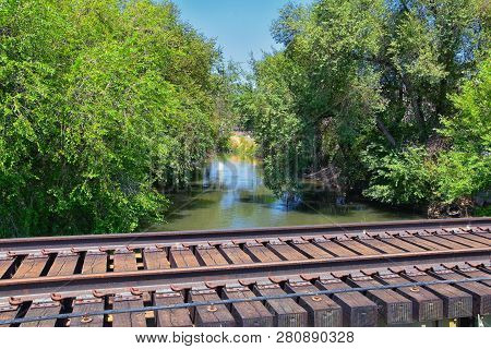 Views Of Jordan River Trail Pedestrian And Train Track Bridge With Surrounding Trees, Russian Olive,