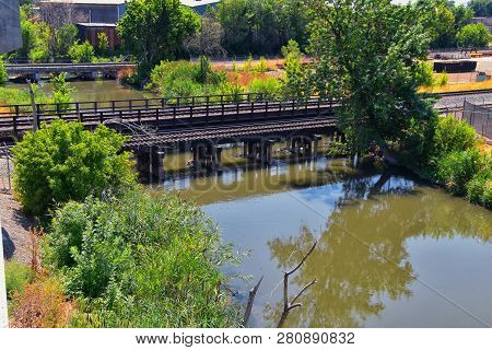Views Of Jordan River Trail Pedestrian And Train Track Bridge With Surrounding Trees, Russian Olive,