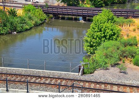Views Of Jordan River Trail Pedestrian And Train Track Bridge With Surrounding Trees, Russian Olive,