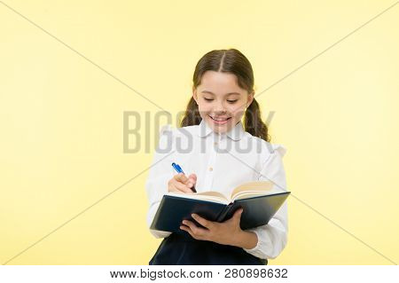 Making Notes. Child School Uniform Kid Doing Homework. Child Girl School Uniform Clothes Hold Book A