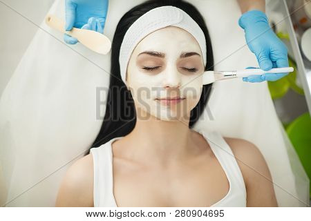 Girl At Spa Salon. Beautician Applying White Cosmetic Powder