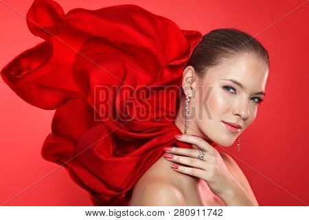 Lady in red scarf with diamod jewellry on red