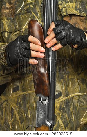 Hands Of The Hunter Separate The Handguard From A Shotgun