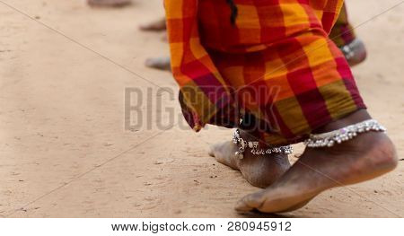 Dirty Bare Feet Of Tribal Female Dancer In Saree With Anklet In Tribal Dance Pose Stance On Ground